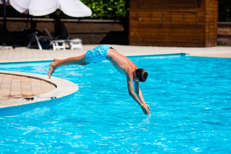 man diving on pool
