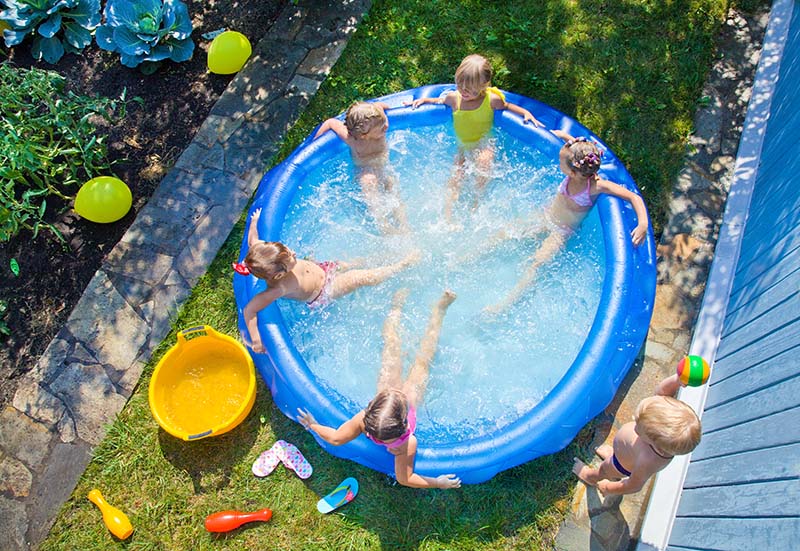 Children playing in inflatable pool