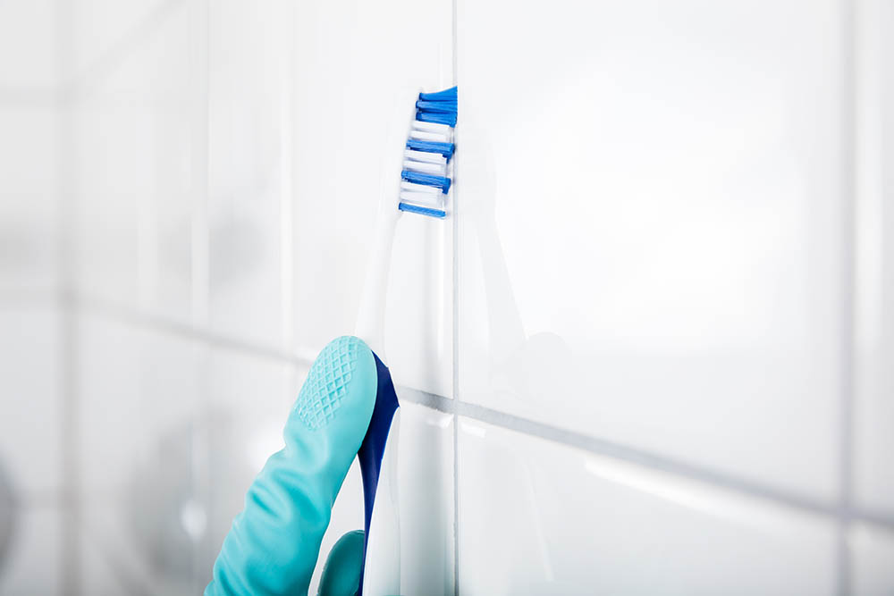 cleaning grout using brush