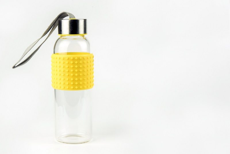Empty glass water bottle on a white_satit sewtiw_shutterstock