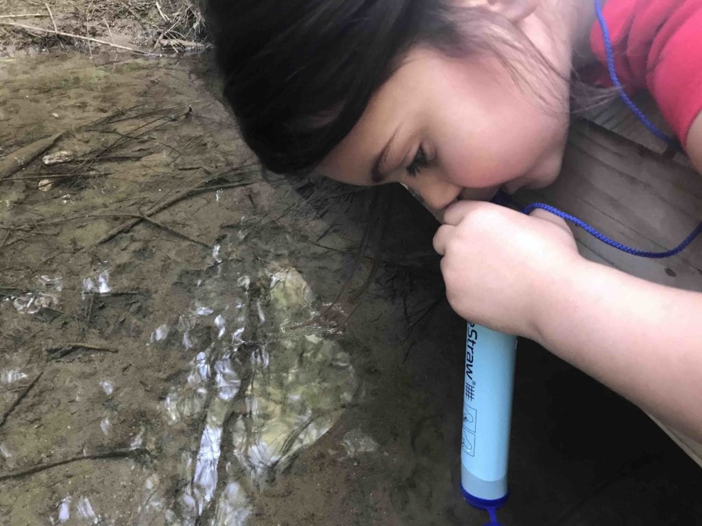 girl using LifeStraw Personal Water Filter