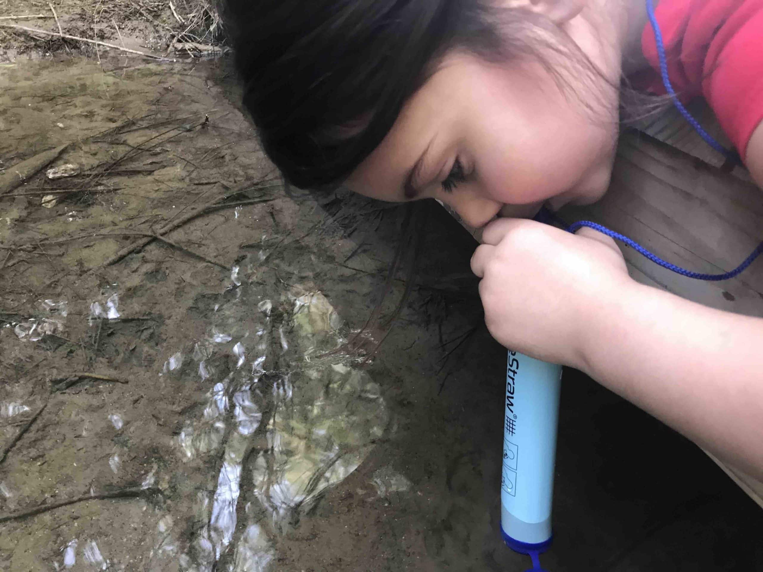 girl using LifeStraw Personal Water Filter