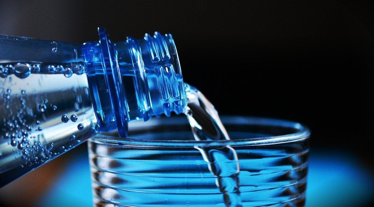 bottled water being poured in the glass