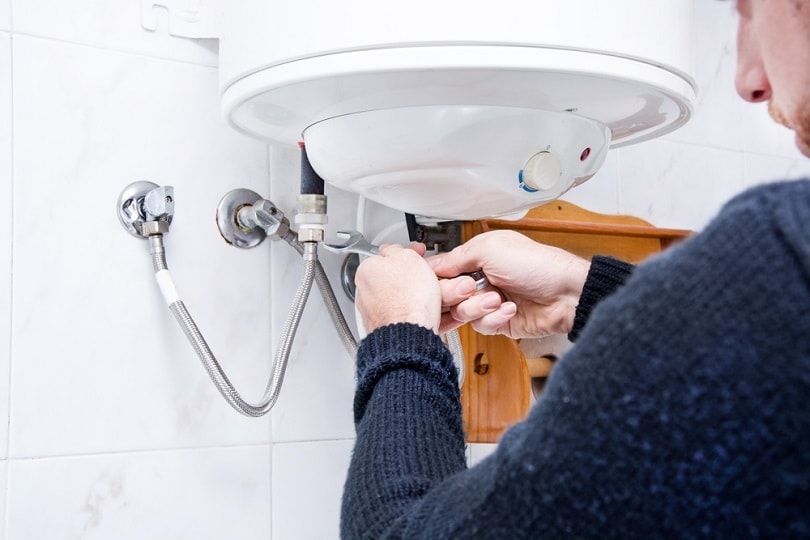 plumber fixing electric water heater
