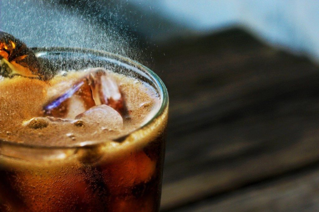 close up photo of a soda in a glass