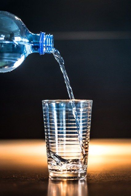 bottled water being poured in the glass