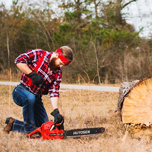 man with chainsaw in an open field