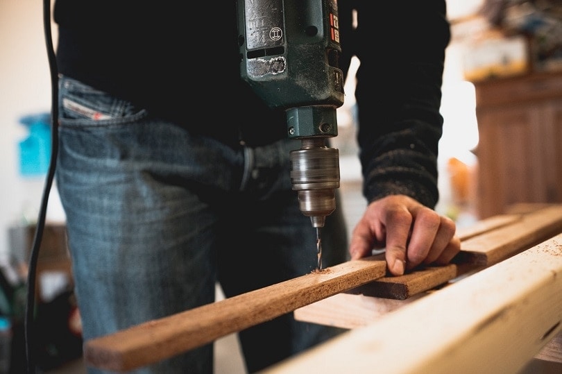 A man drilling a hole