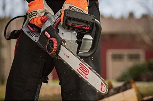 Worker using a corded chainsaw