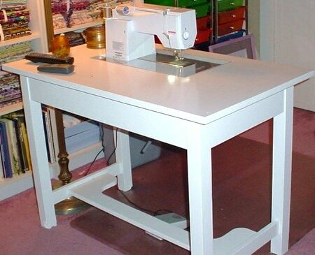 Sewing machine cabinet table