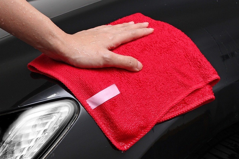 Wiping a car with a towel