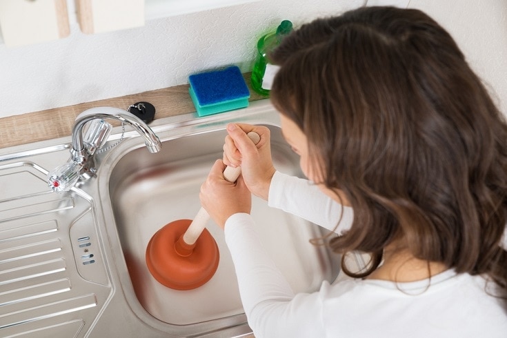 Woman Using Plunger