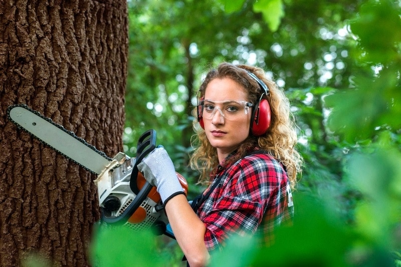 Woman with chainsaw