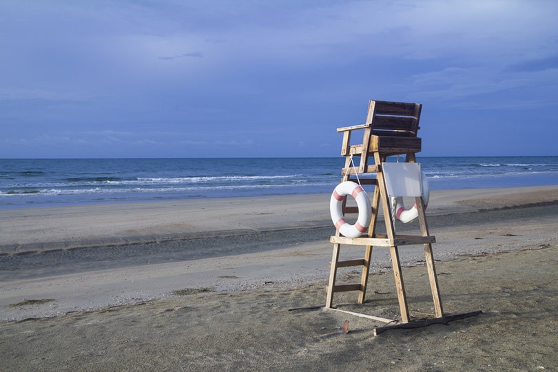 a lifeguard chair on an emply stormy beach