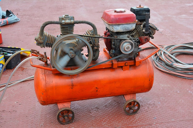 an orange painted air compressor