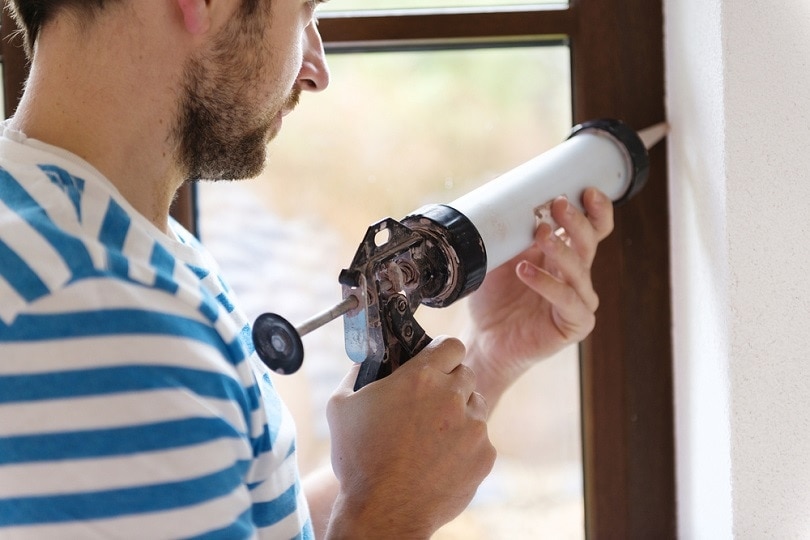 applying silicone sealant with caulking gun