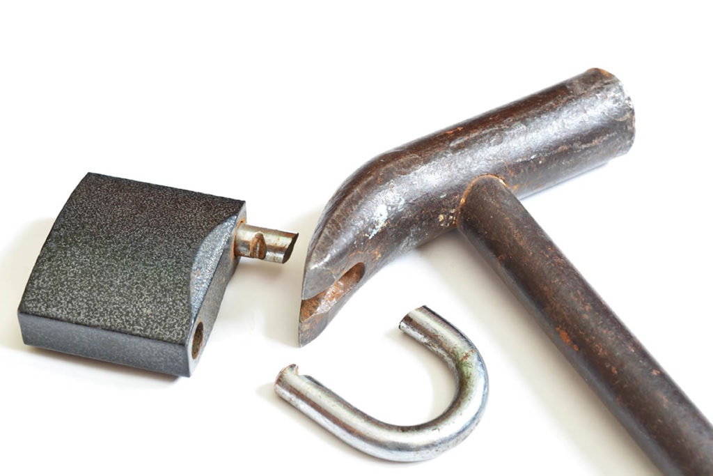 Broken padlock and a hammer