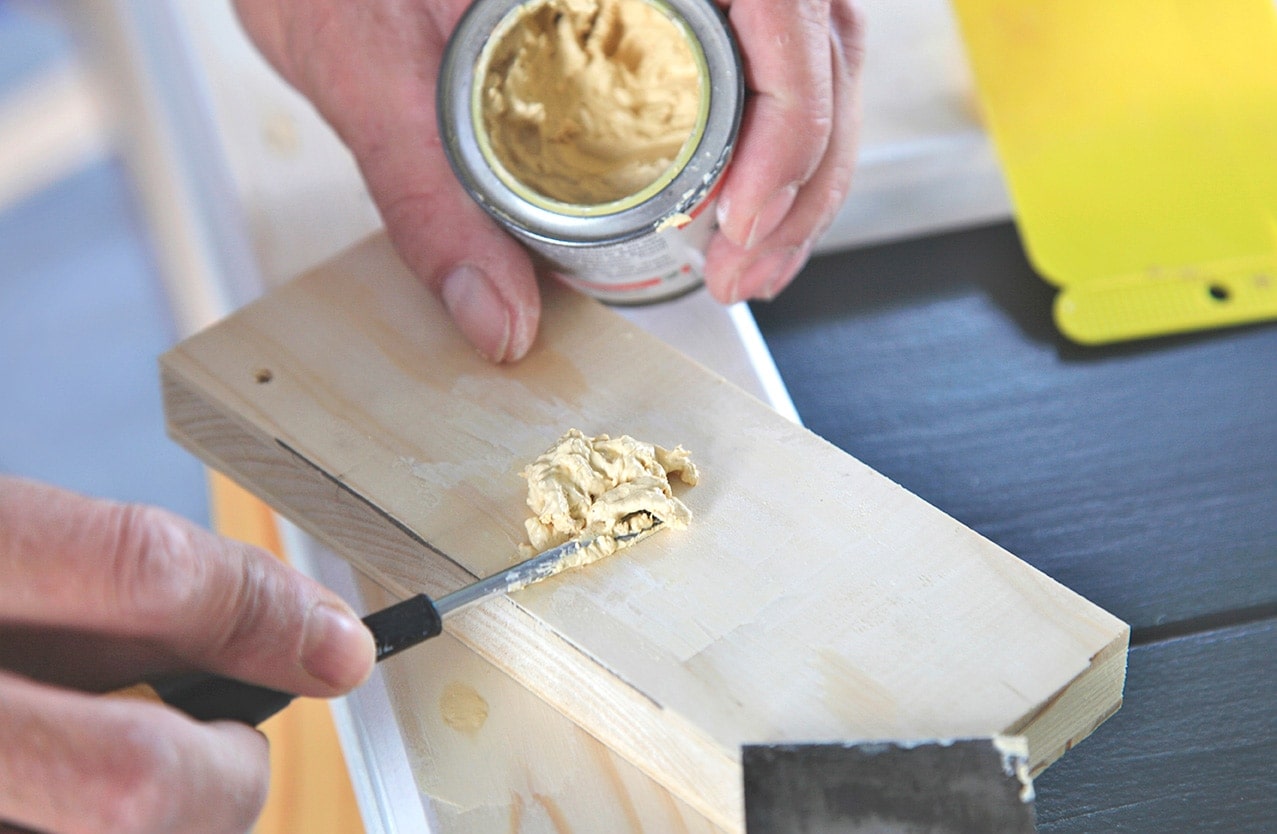 close up photo of person applying wood putty