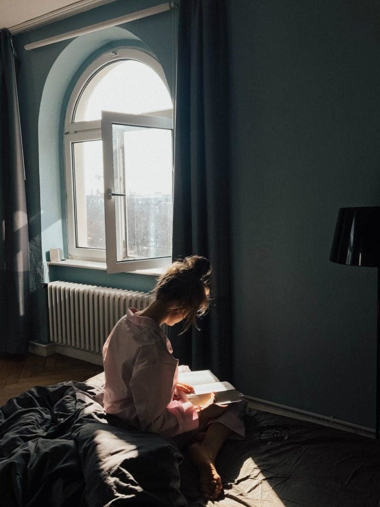 girl inside a room with open window
