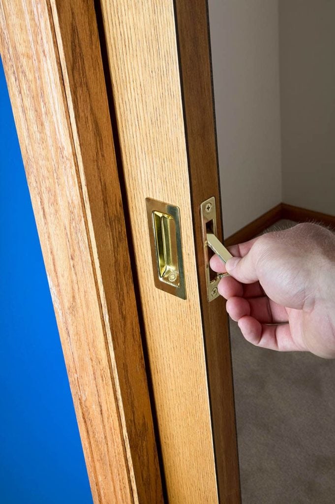 hand fixing a pocket door