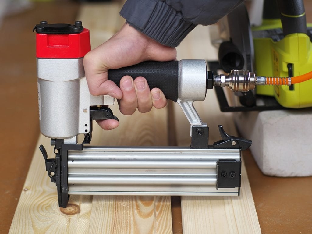 hand holding a brad nailer