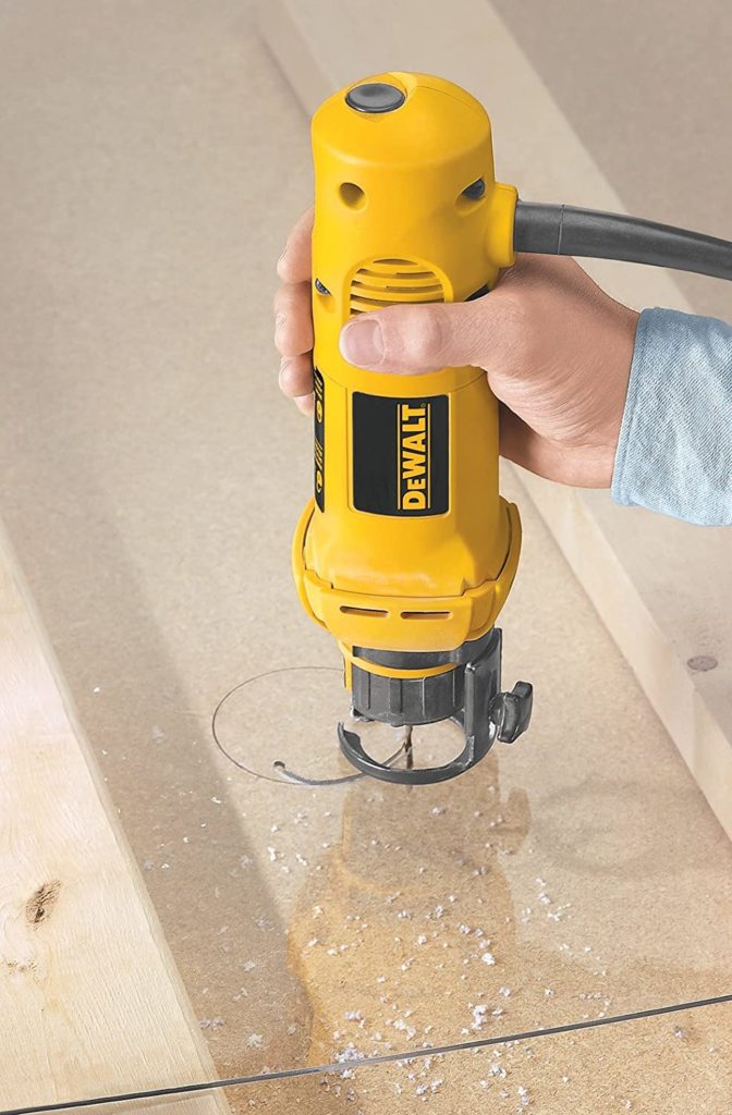 hand using DEWALT DW660 Rotary Saw
