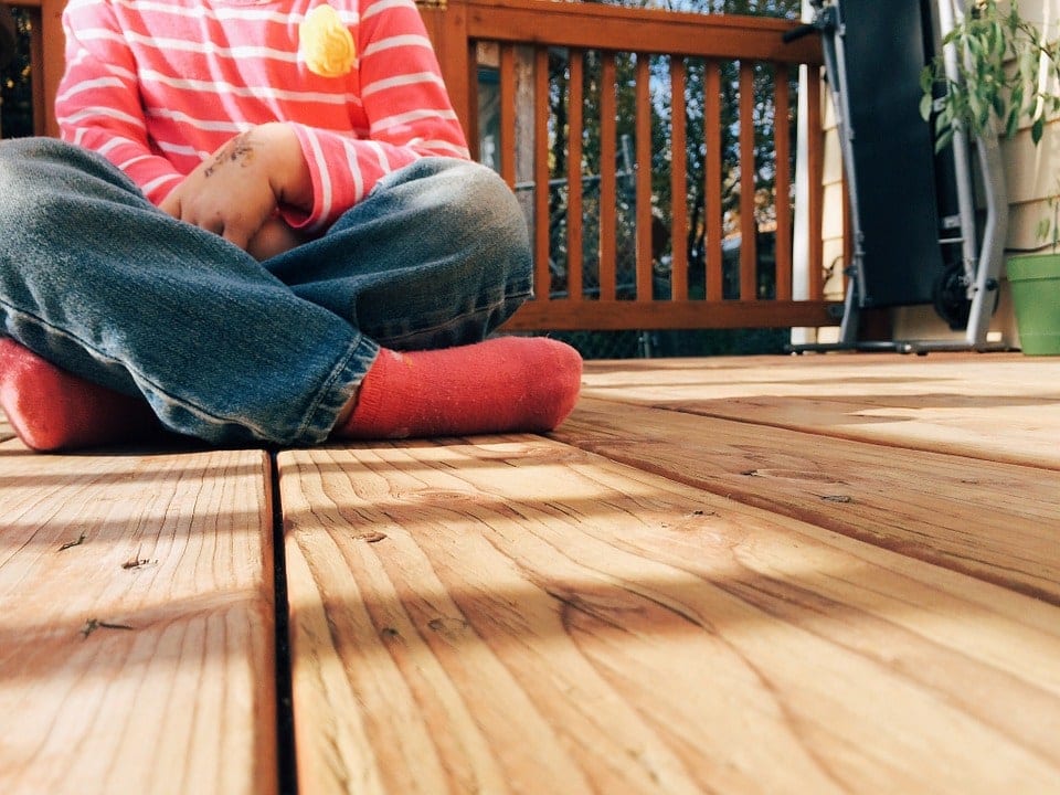 kid sitting in the porch deck