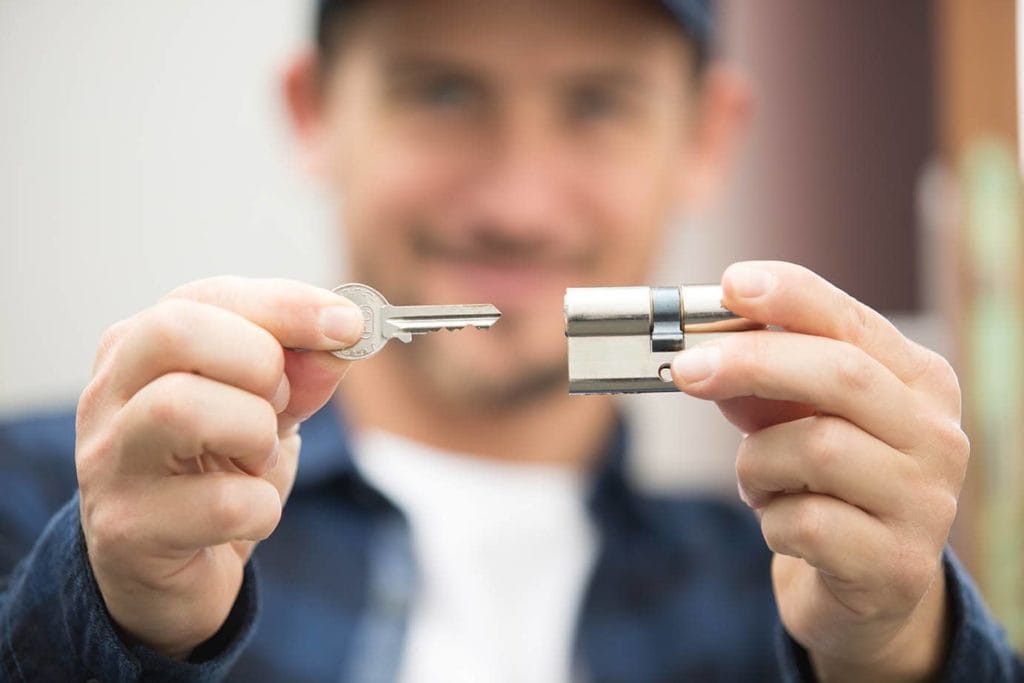 locksmith holding padlock and key