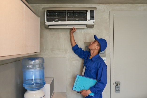 man checking air conditioner