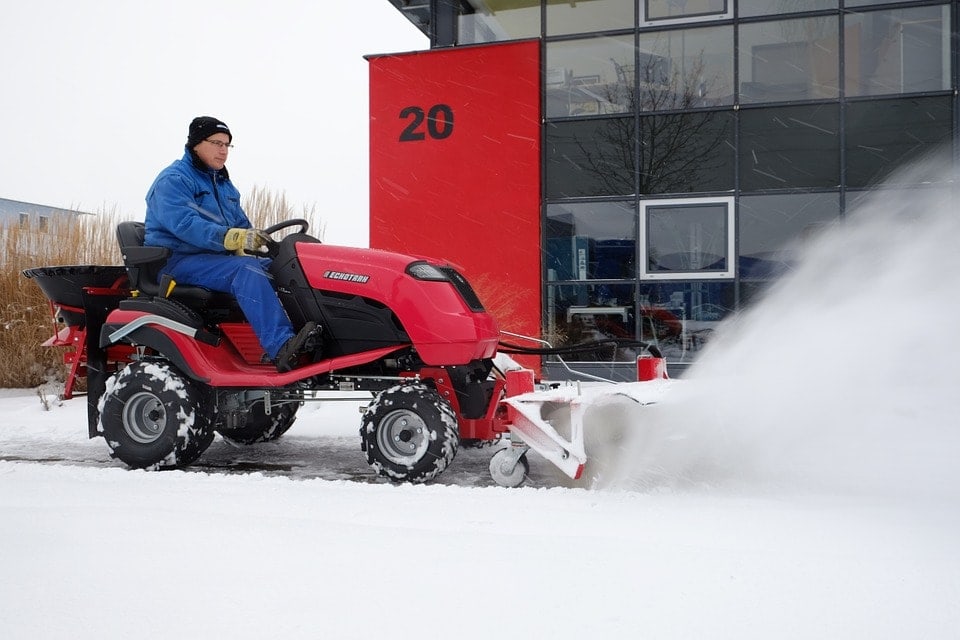 man-clearing-snow-with-tractor