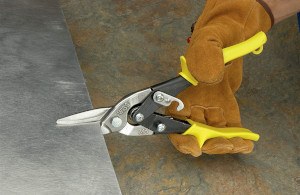 man cutting metal sheet