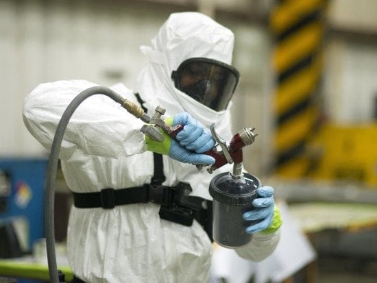 man loads a paint sprayer