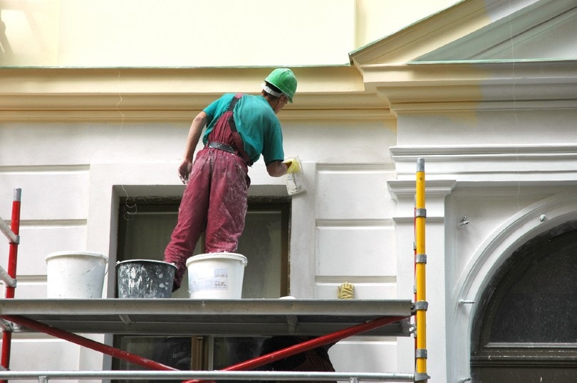 man painting house
