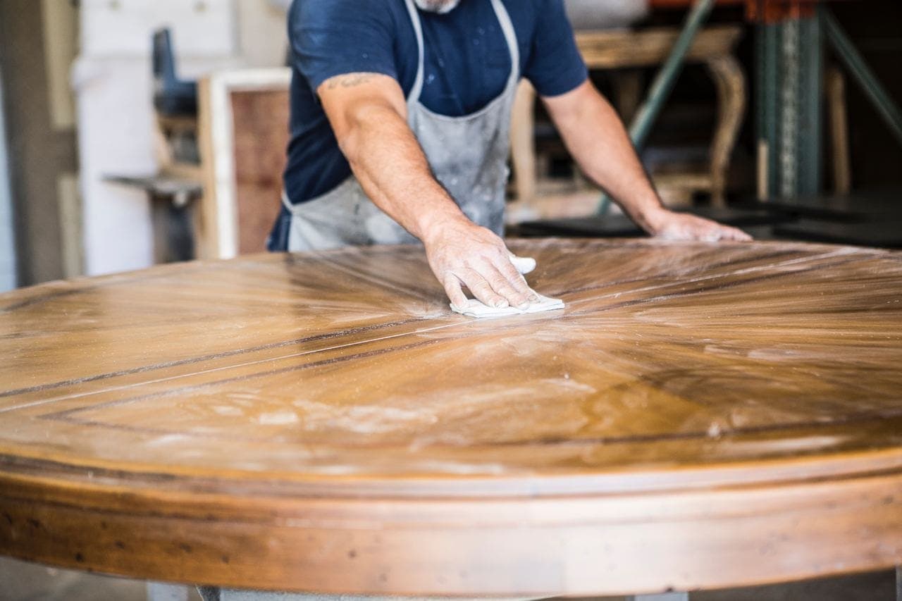 man sanding table