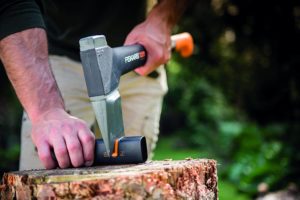 man sharpening axe using Fiskars 1000601 XSharp Axe Sharpener