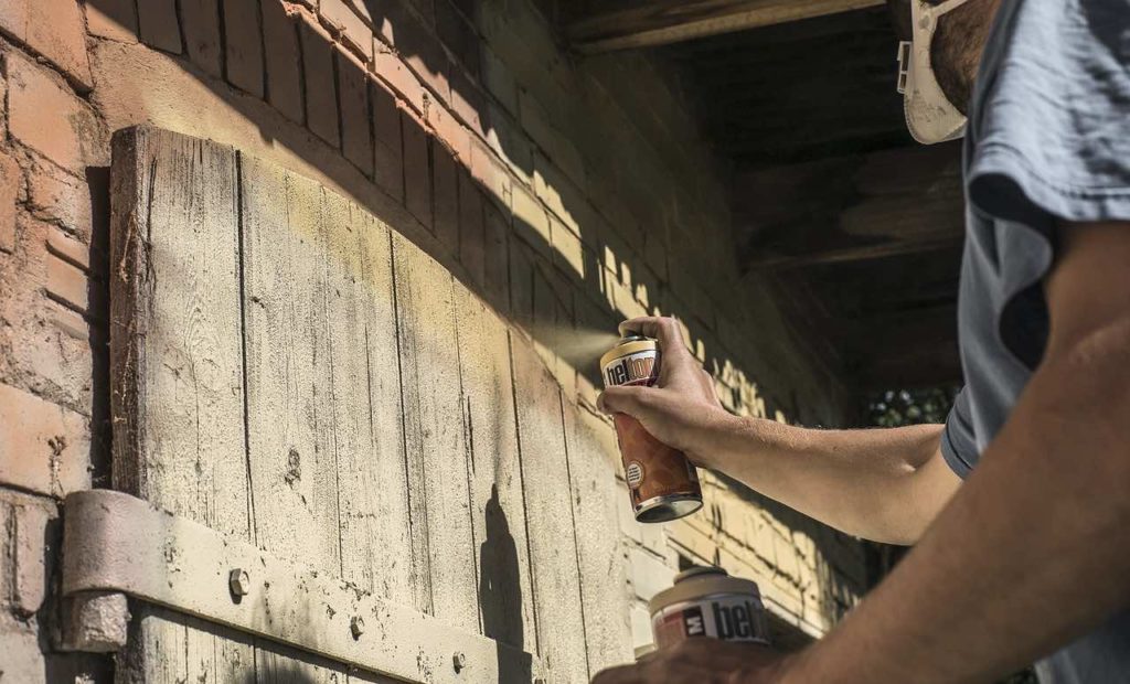 man spray painting