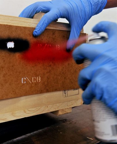 man spraying paint with stencil