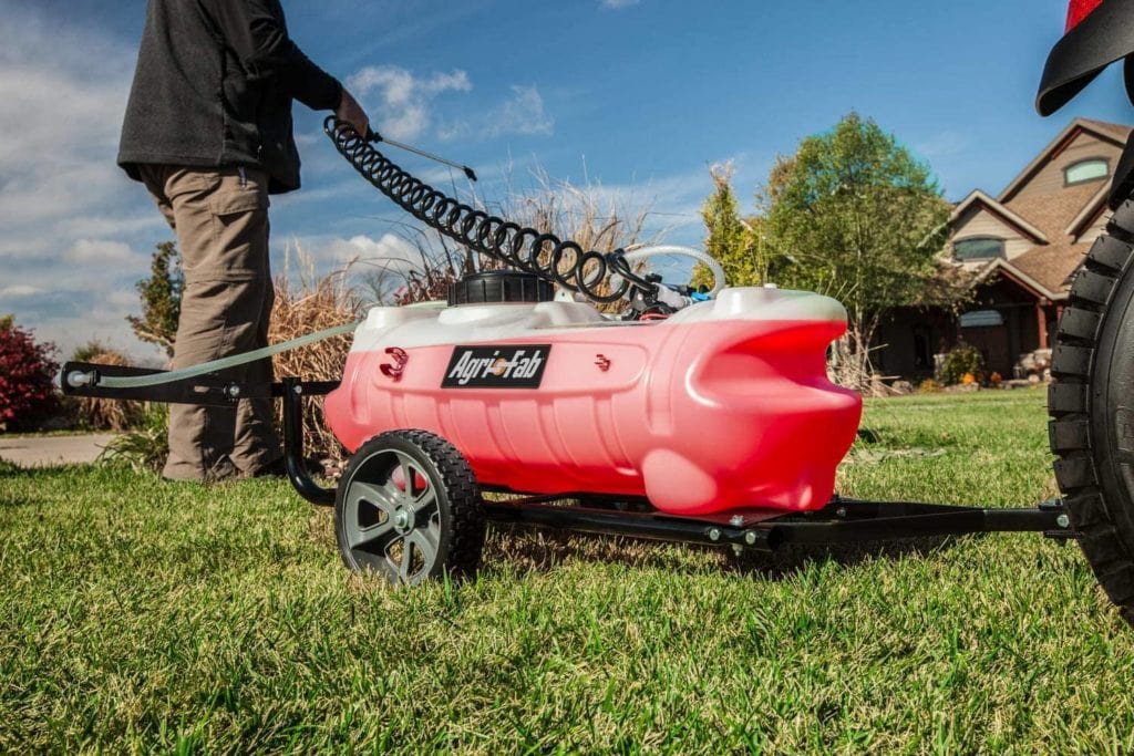 man using Agri-Fab 45-0292 Tow Sprayer