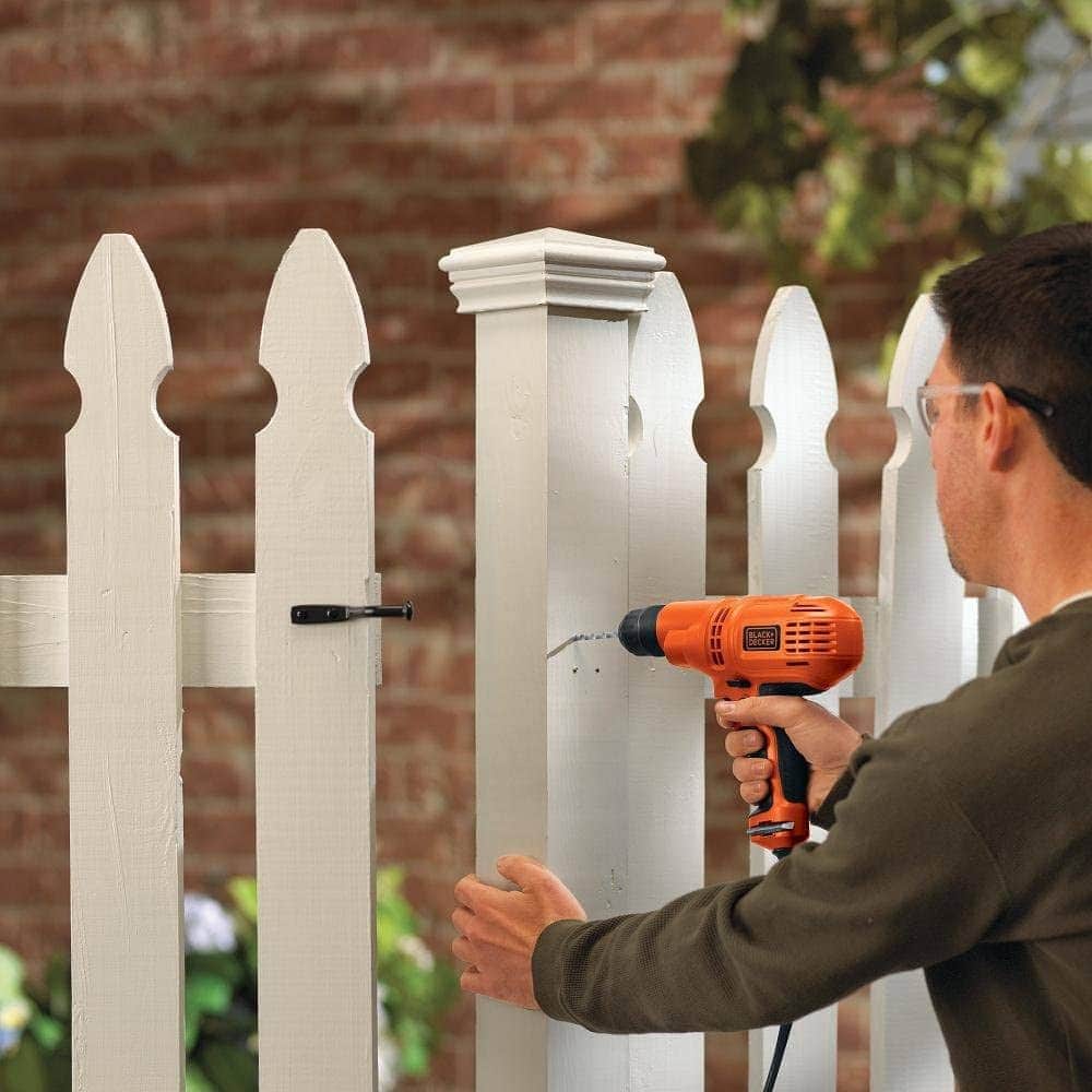 man using BLACK+DECKER DR260C Corded Drill