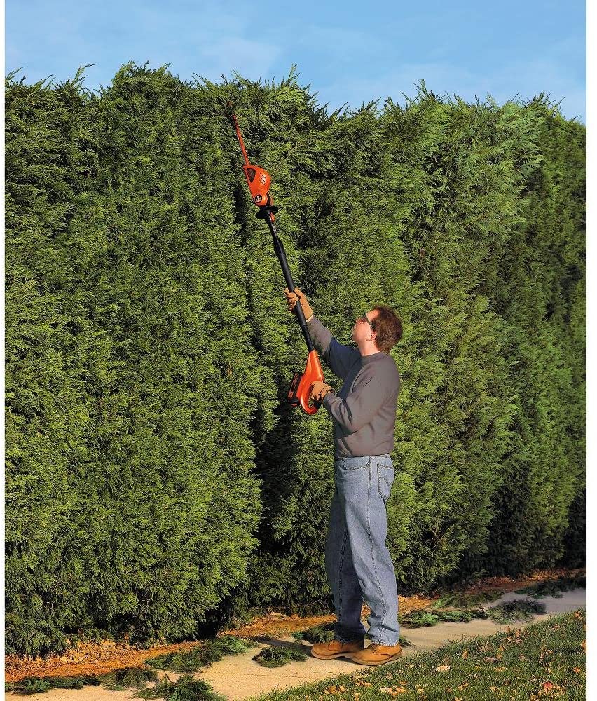man using BLACK+DECKER LPHT120 Cordless Pole Hedge Trimmer