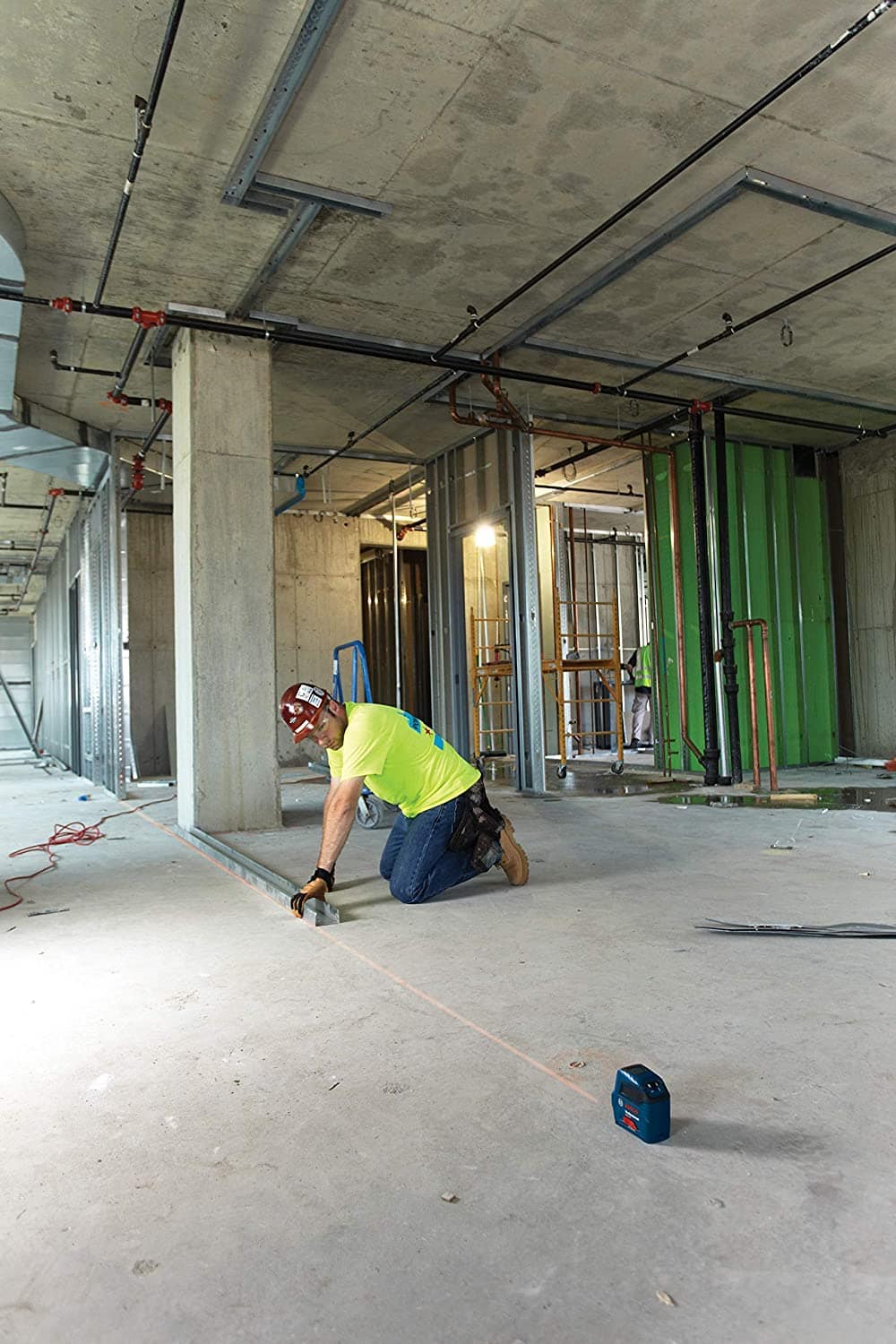 man using Bosch Self-Leveling Cross-Line Red-Beam Laser Level GLL 55