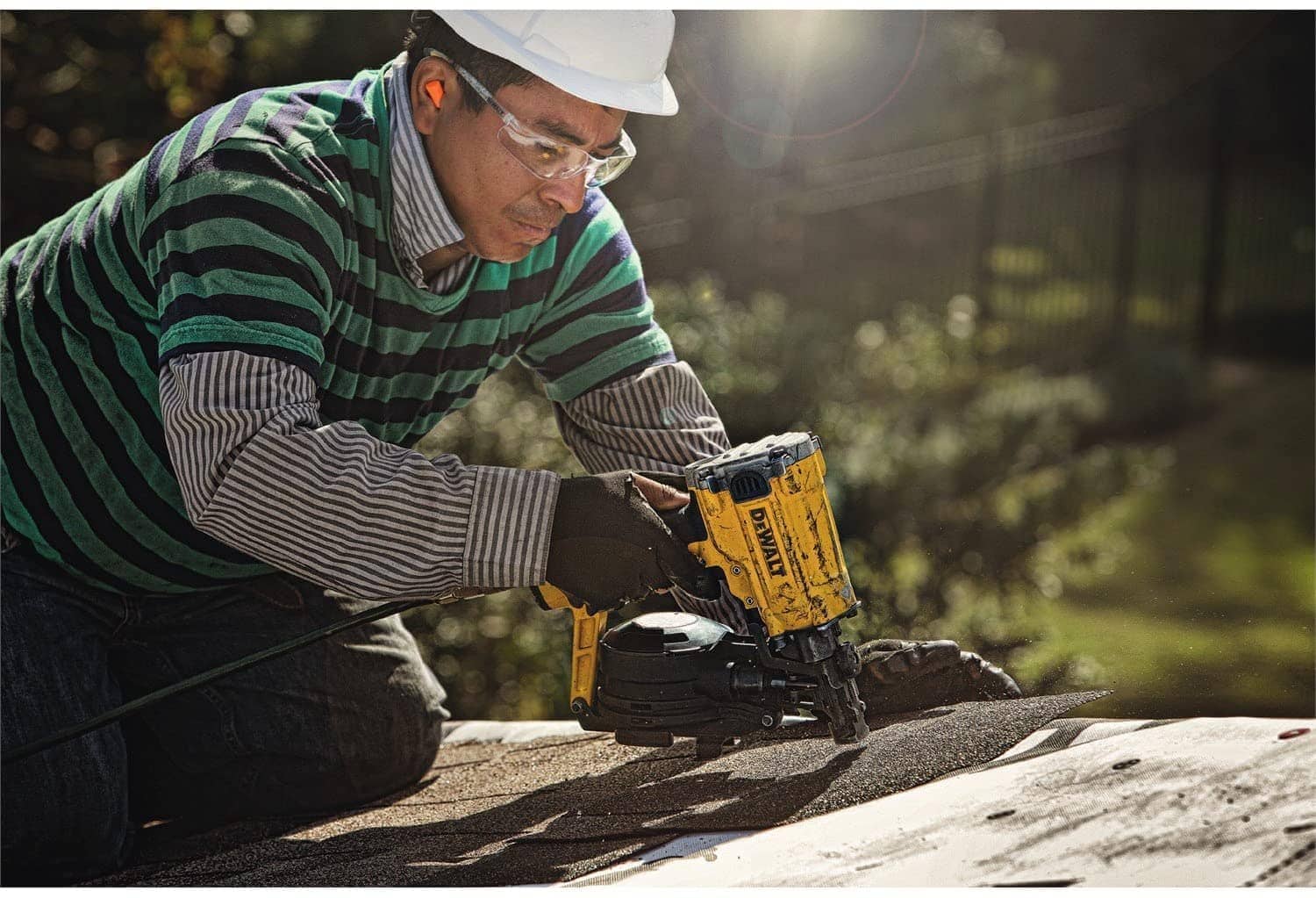 man using DEWALT DW45RN Pneumatic Coil Roofing Nailer