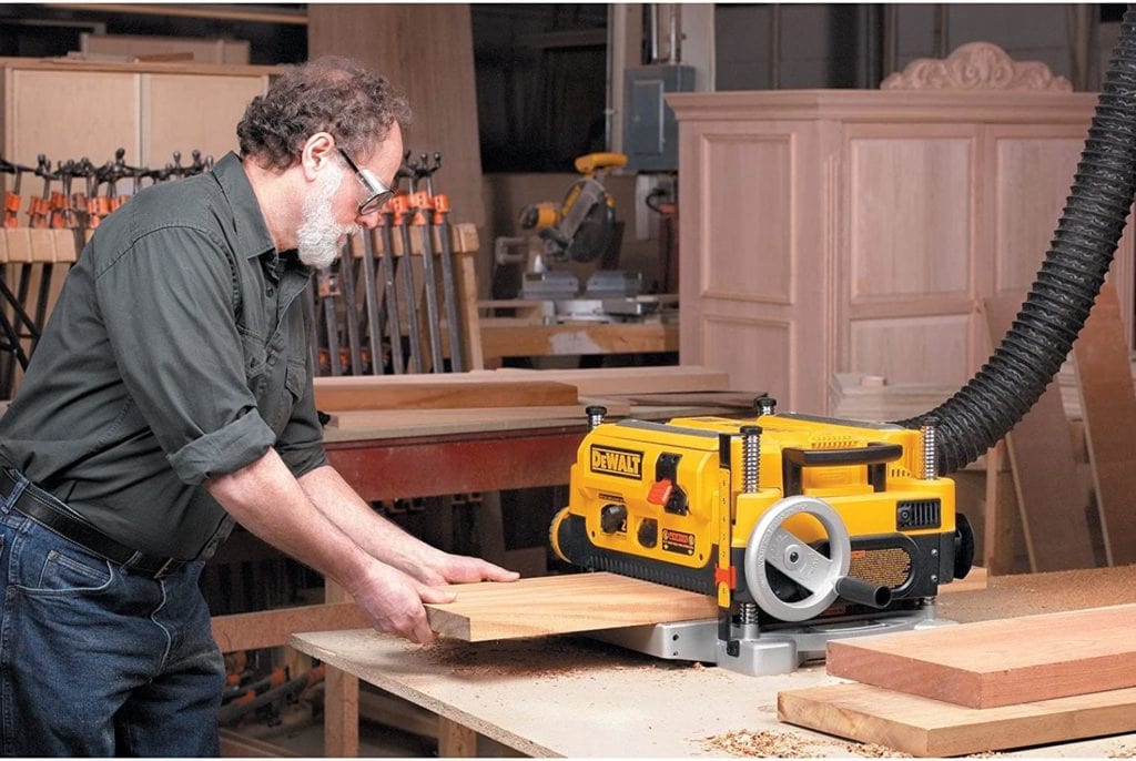 man using DEWALT DW735 Thickness Planer