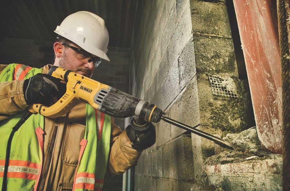 man using DEWALT Rotary Hammer Drill with Shocks