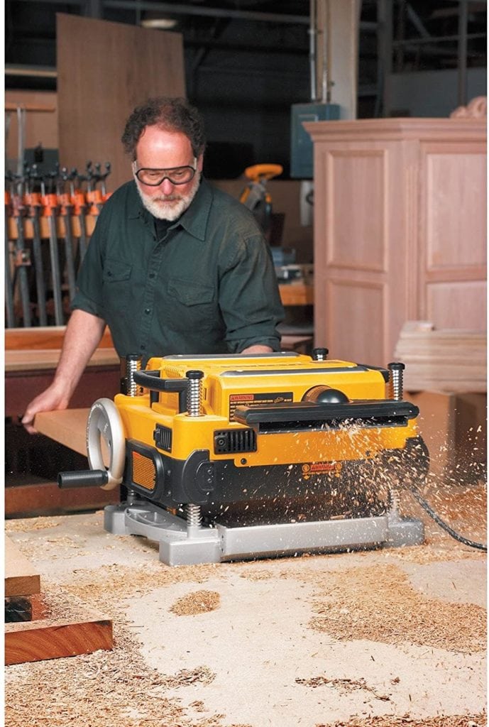 man using DEWALT Thickness Planer DW735