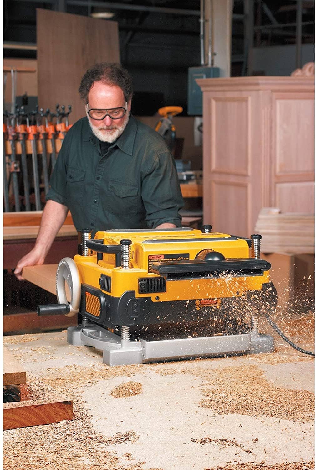 man using DEWALT Thickness Planer DW735