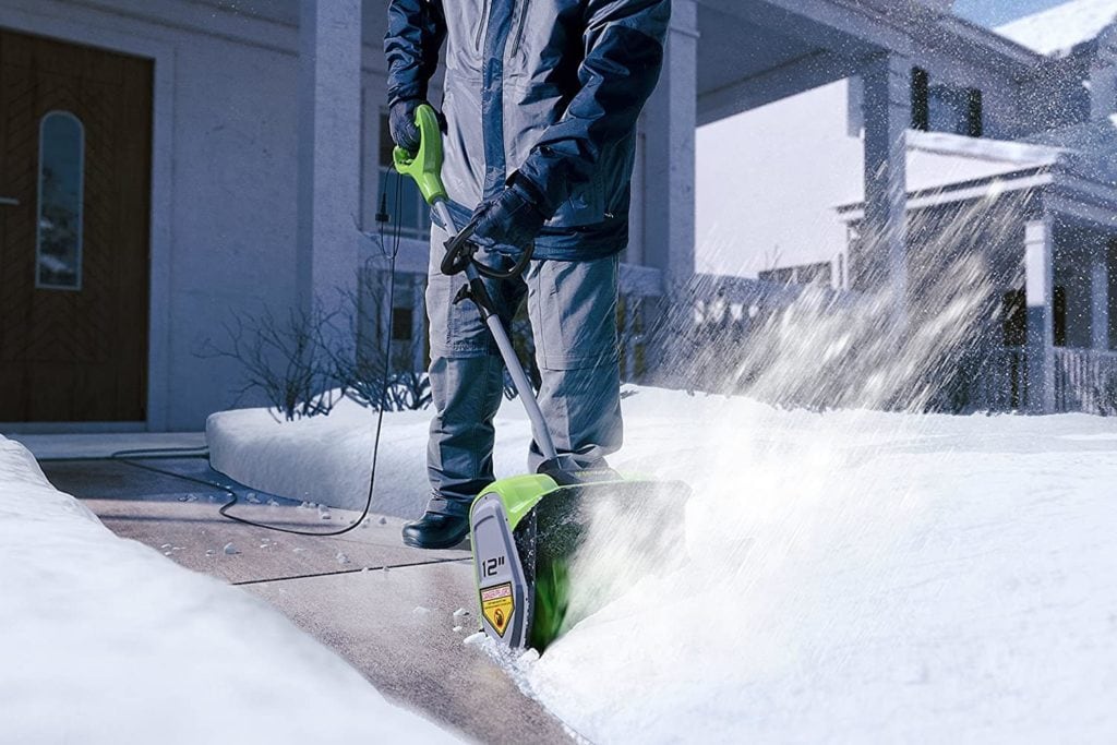 man using Greenworks 2600802 Corded Snow Shovel