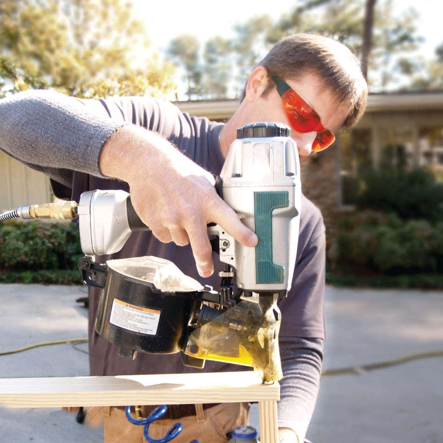 man using Makita AN611 Siding Coil Nailer
