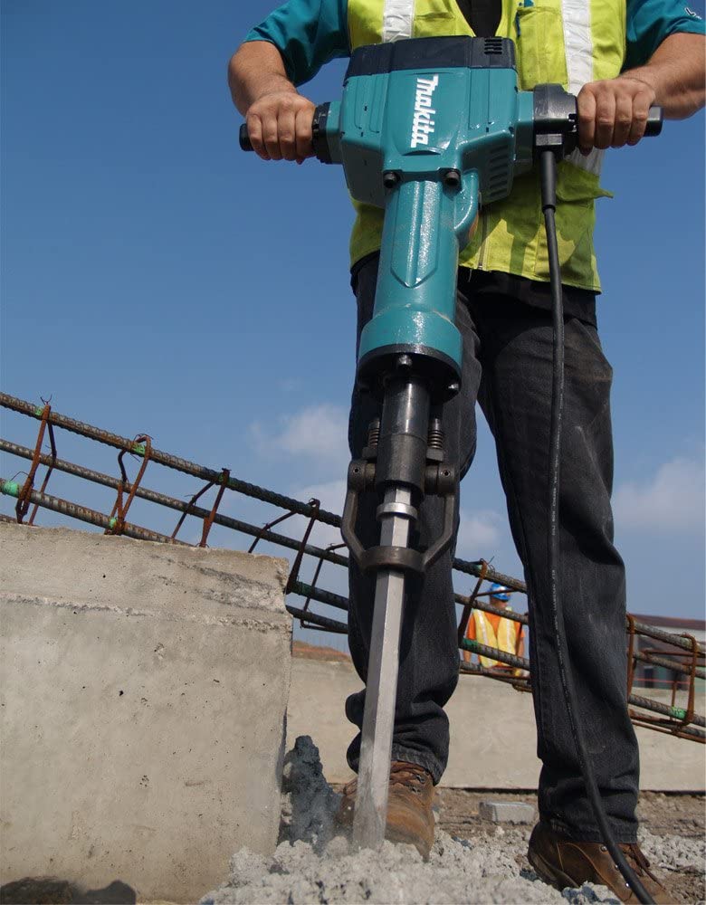 man using Makita HM1810X3 AVT Breaker Hammer