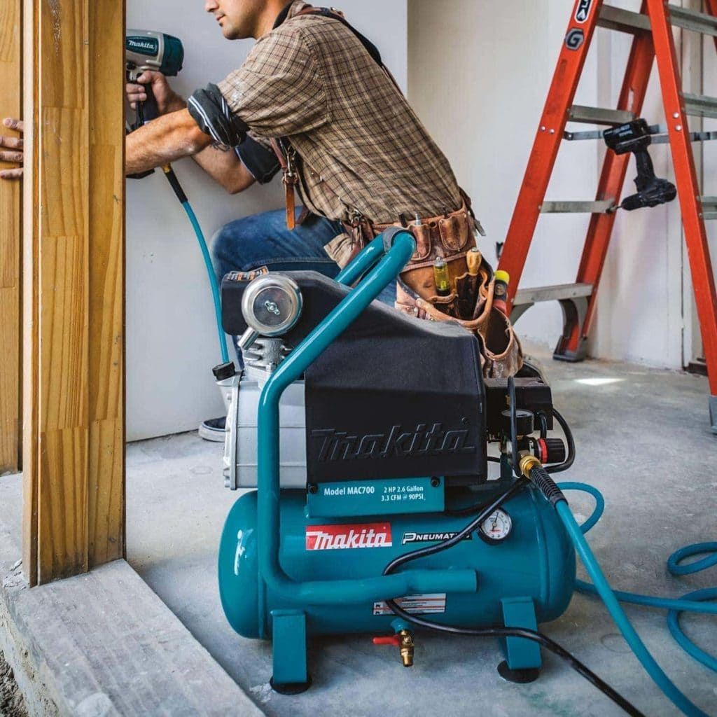 man using Makita MAC700 Air Compressor